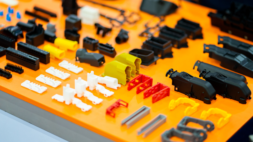 A collection of plastic and rubber parts arrayed on a tray as part of a manufacturing process