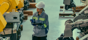 Robot engineer examining an industrial robot