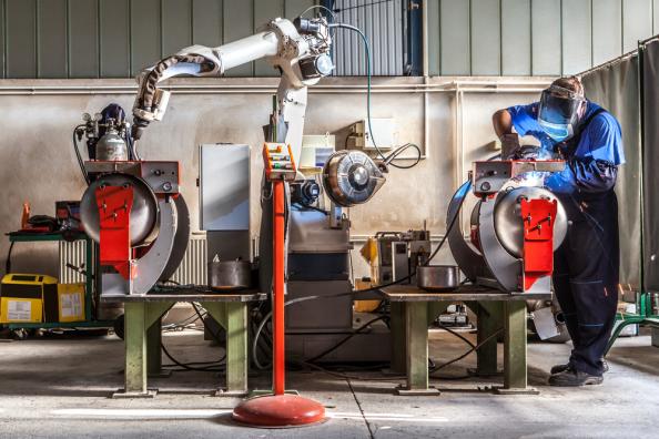 A machinist utilizing a cobot in a manufacturing application